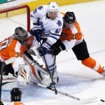 Flyers goalie Bryzgalov pokes the puck away