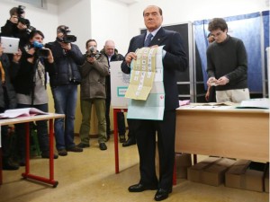 Silvio Berlusconi shows off his ballot