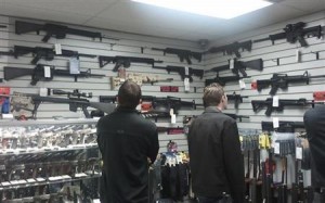 Customers view rifles on display at a gun shop in LA