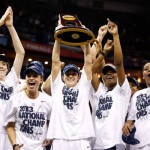 UConn's Kelly Faris holds aloft the trophy as she and her teammates celebrate their victory