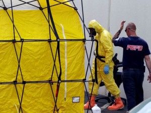 A PG County fireman in a protective suit enters a decontamination are a after tests in the Hyattsville mail handling facility