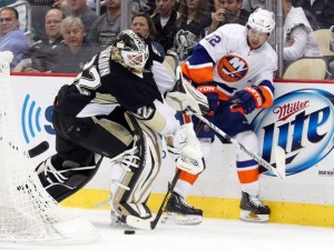 Pens goalie Vokoun struggles for the puck against Islanders center Bailey